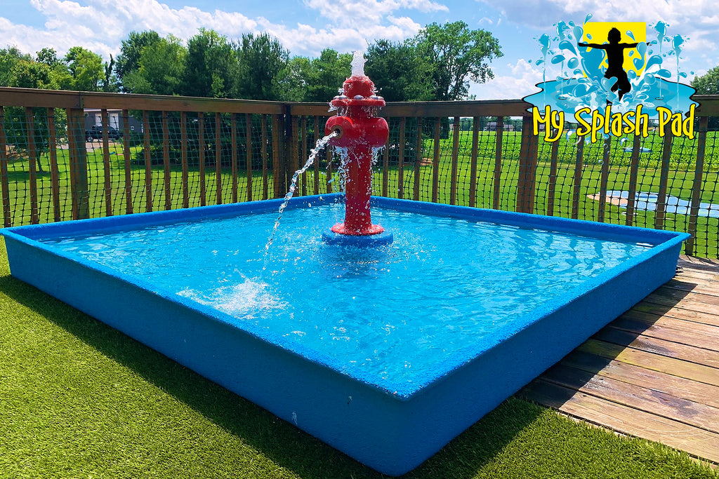 Portable dog water park with red fire hydrant spray feature