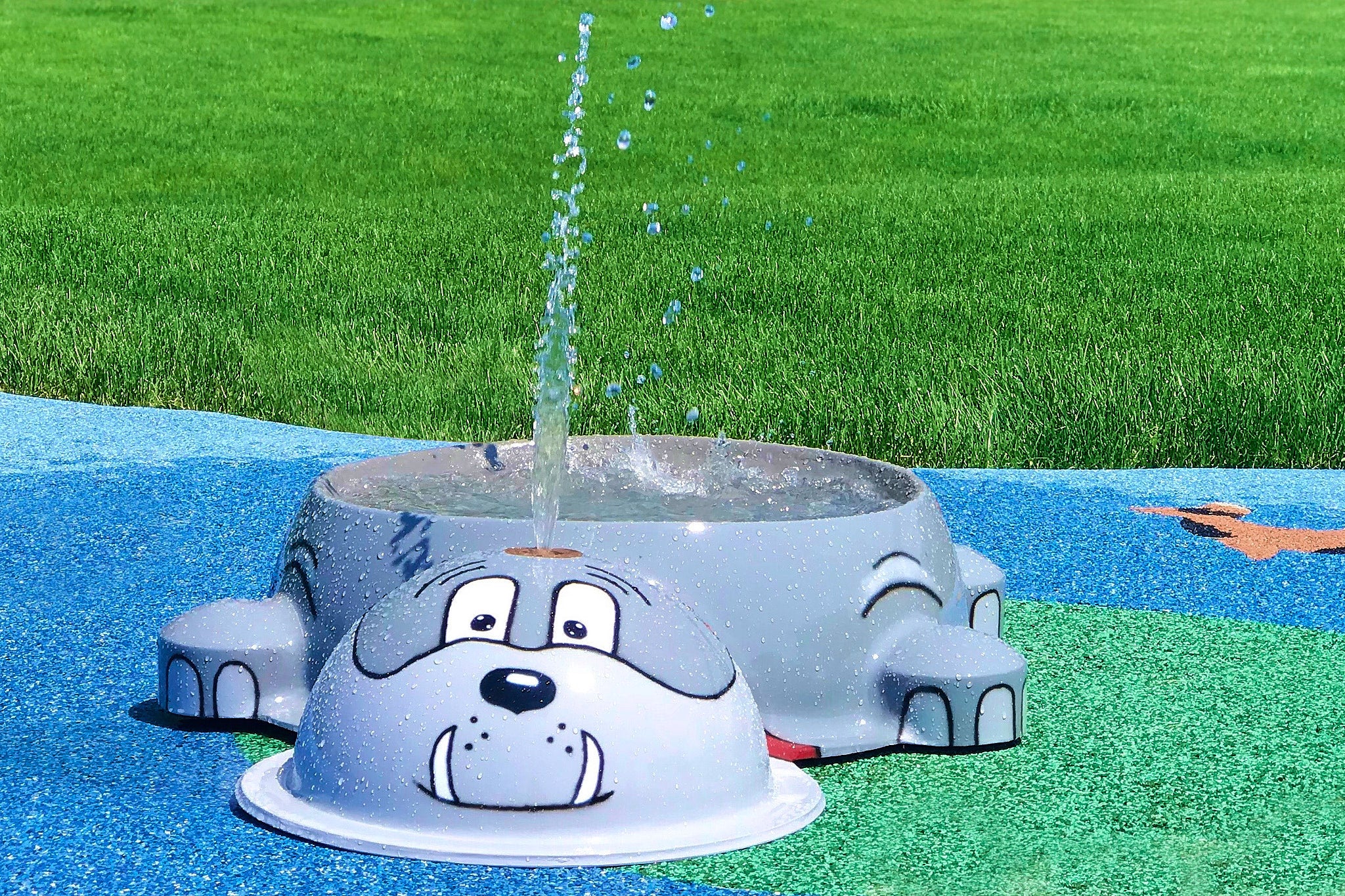 Gray bulldog water bowl feature spraying water at a dog water park